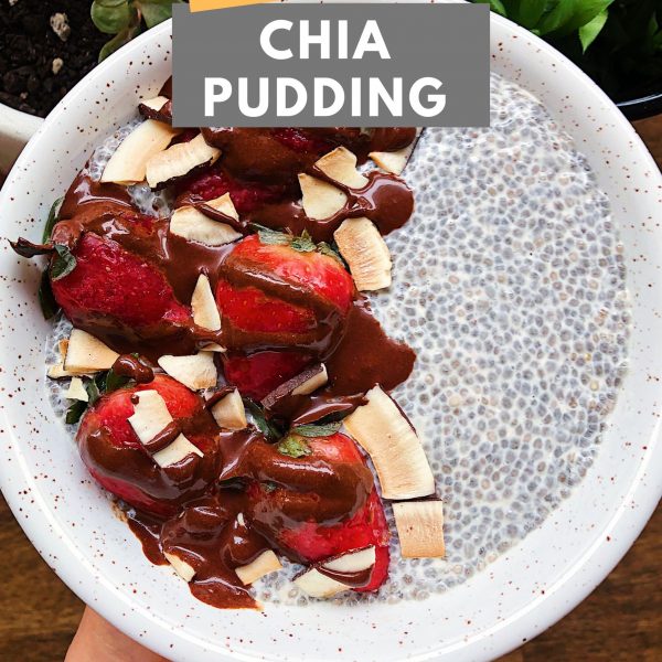 Hand holding bowl of chia pudding