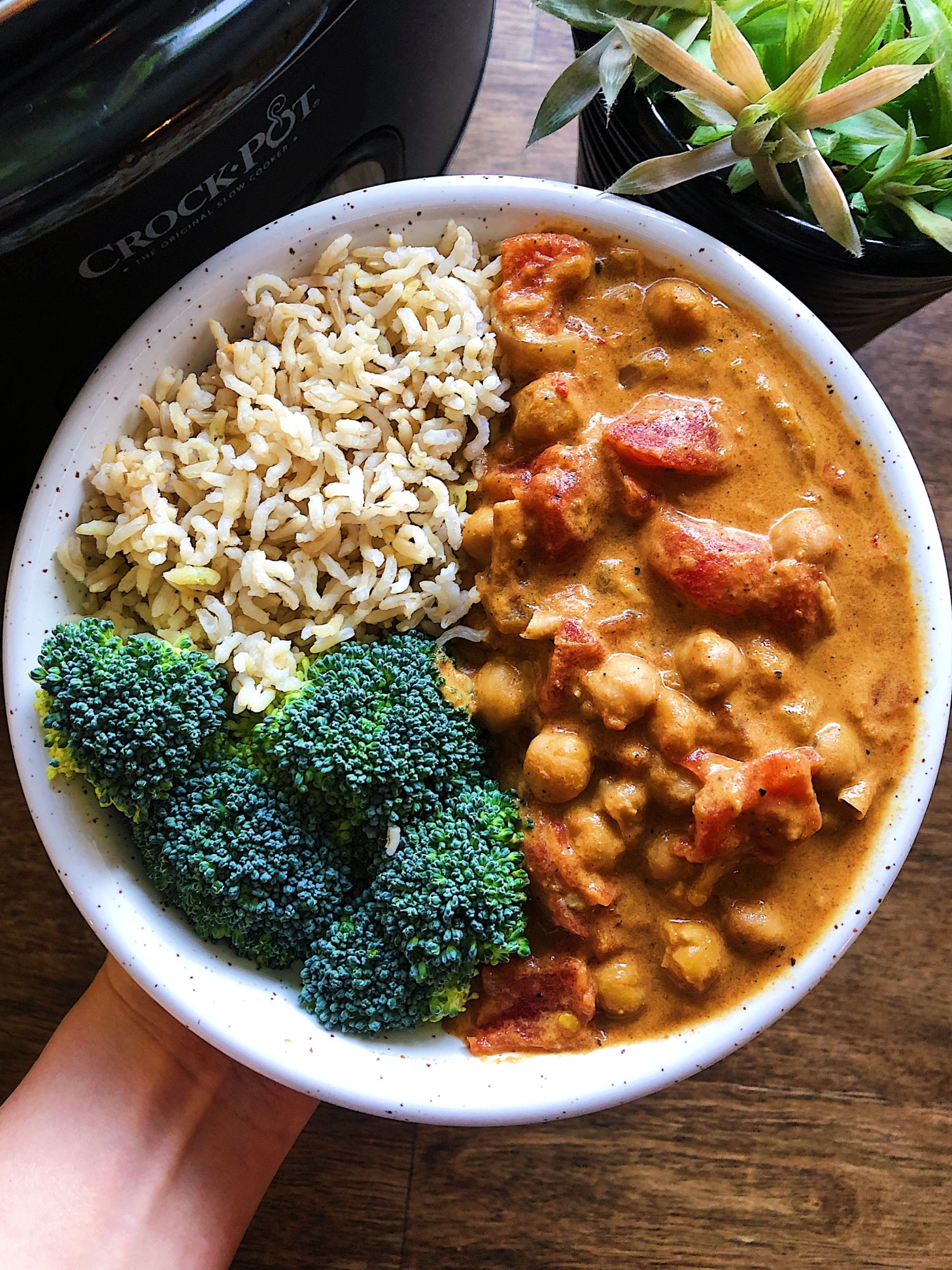 Bowl of vegan butter chickpeas with brown rice and broccoli.