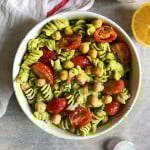 Photo of bowl of pasta with pesto on it and chickpeas and sundried tomatoes.