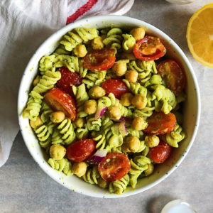 Photo of bowl of pasta with pesto on it and chickpeas and sundried tomatoes.