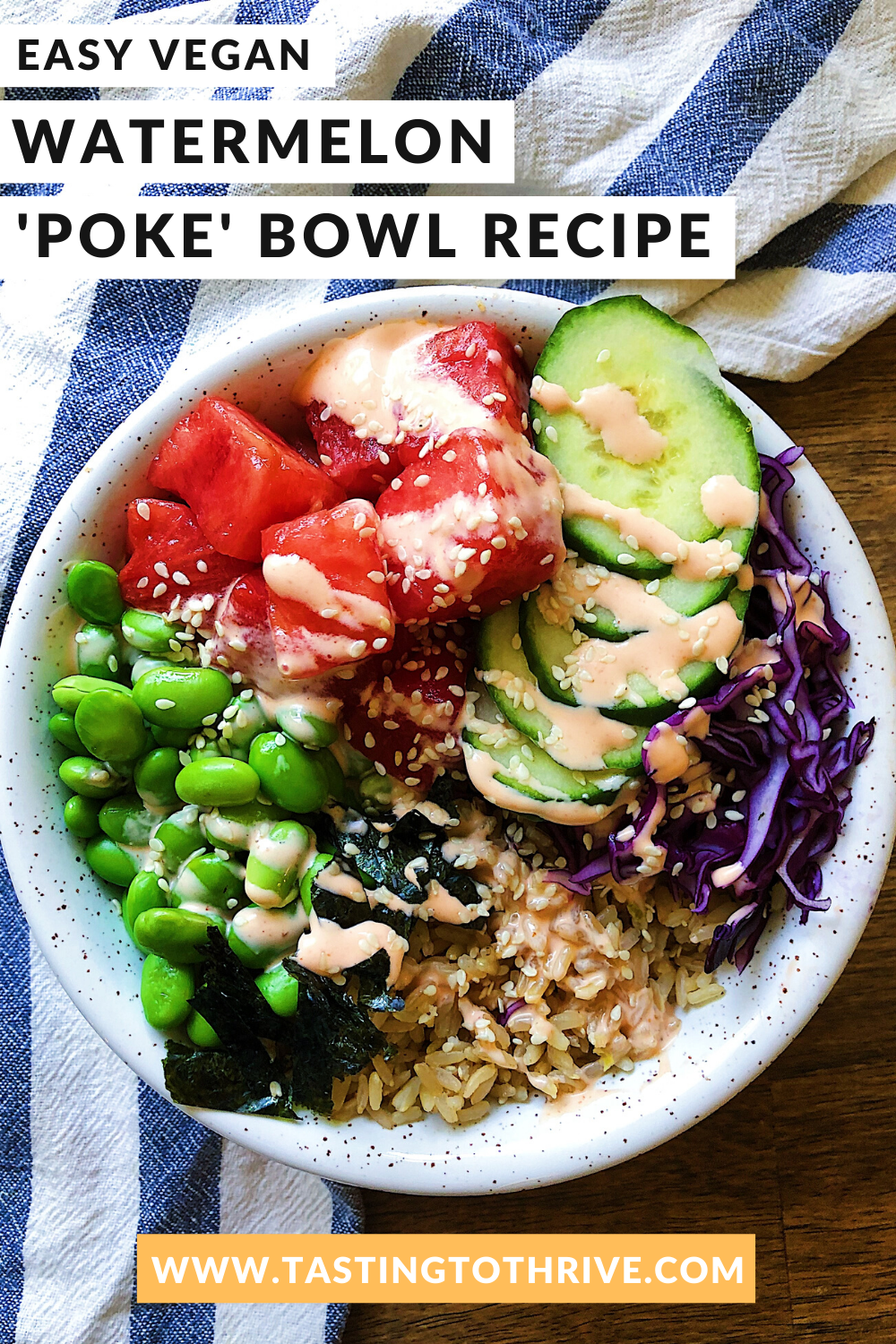 Bowl of watermelon poke with cucumber, edamame, cabbage and brown rice with sriracha mayo on top.
