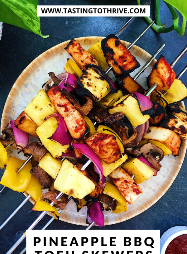 Plate of pineapple BBQ tofu skewers with homemade BBQ sauce on the side