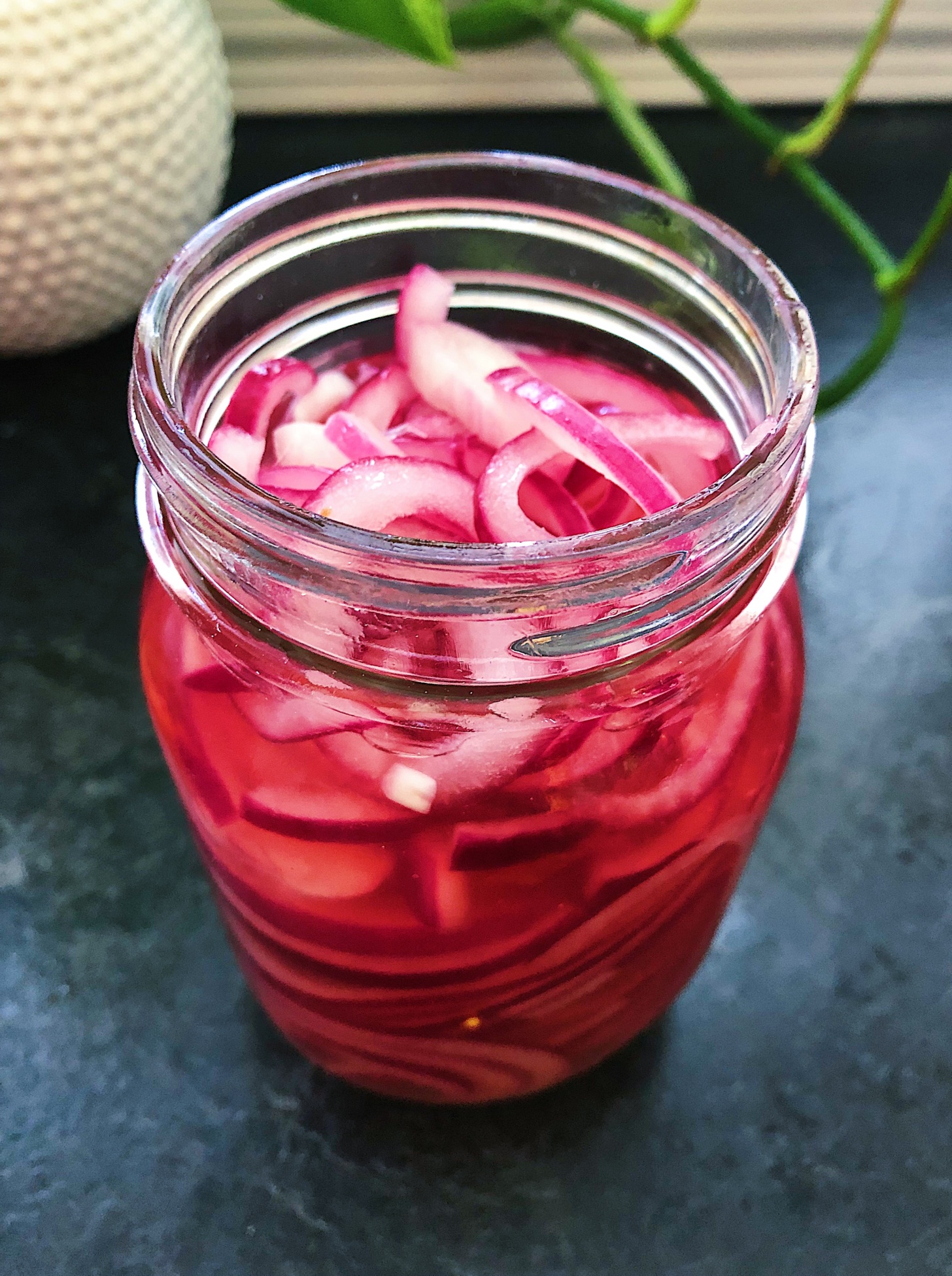 Jar of red onions pickled.
