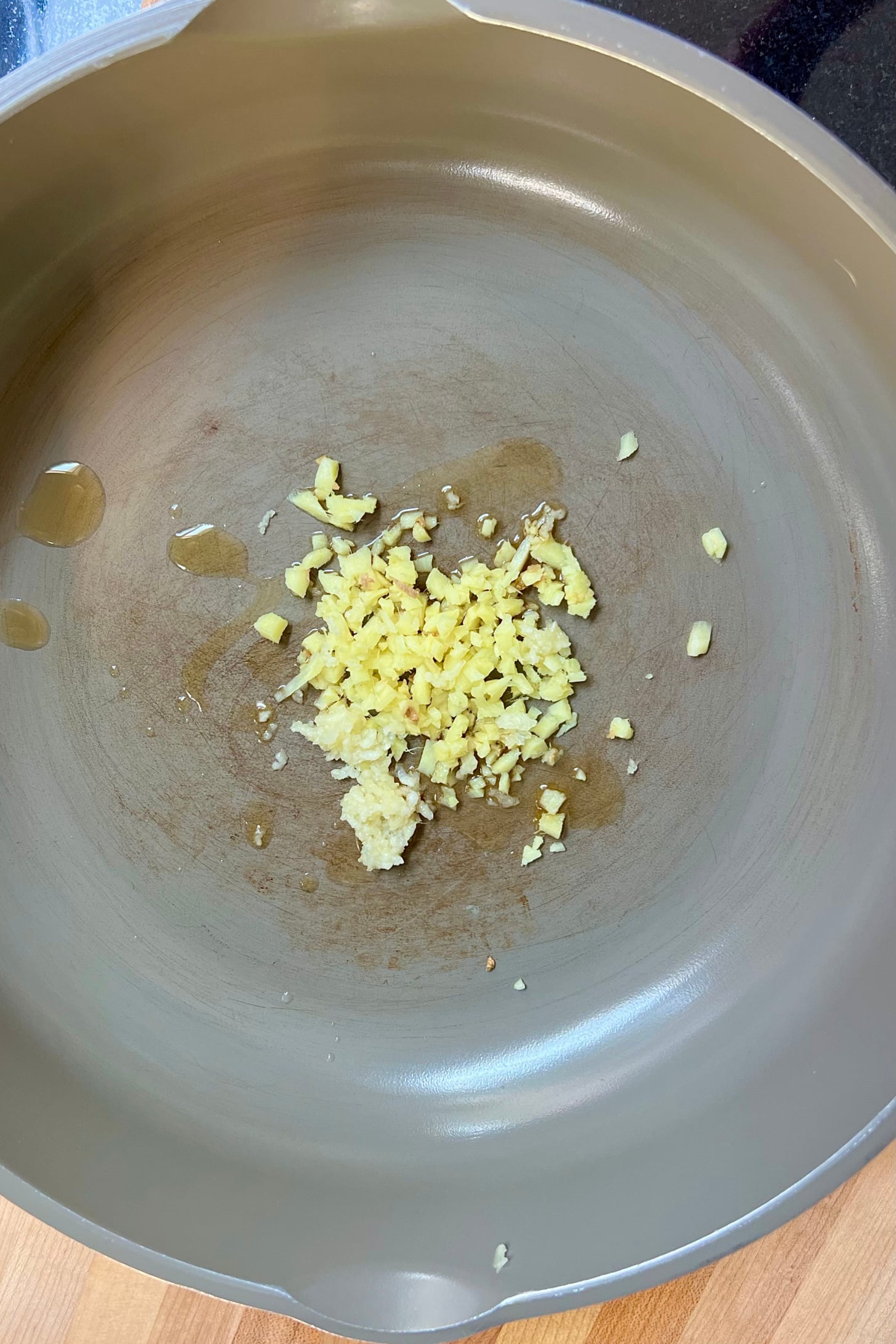 Pan with minced garlic and ginger in it.