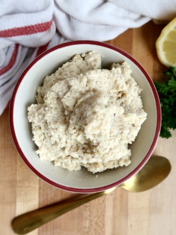 Bowl of vegan ricotta and lemon to the side.