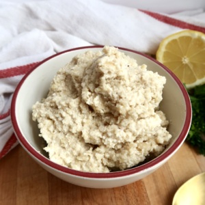 Side view of bowl of vegan ricotta and lemon to the side.