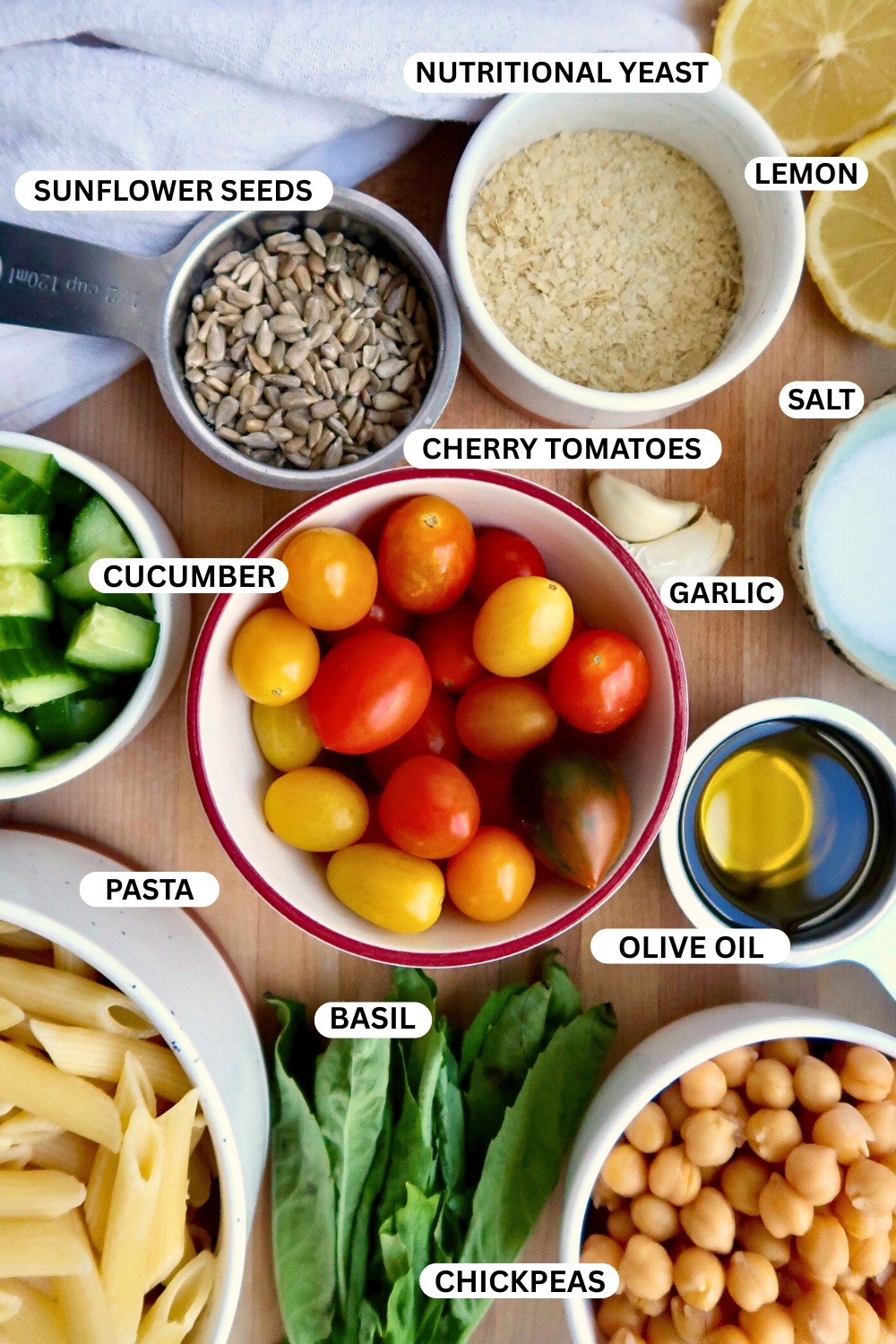 Flatlay of ingredients for vegan pesto pasta recipe.