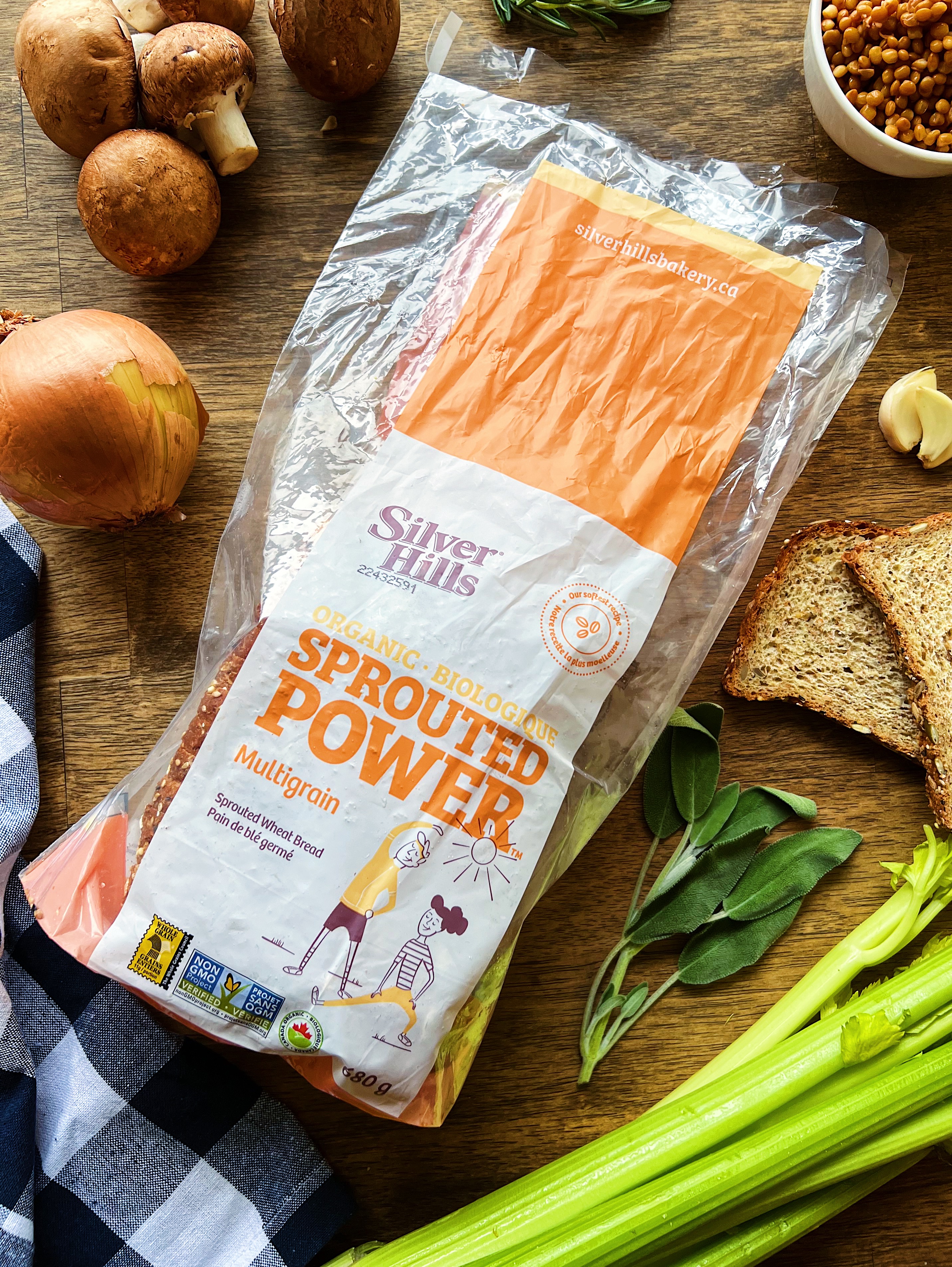 Bag of bread, onion, sage, celery and bread on a table. 