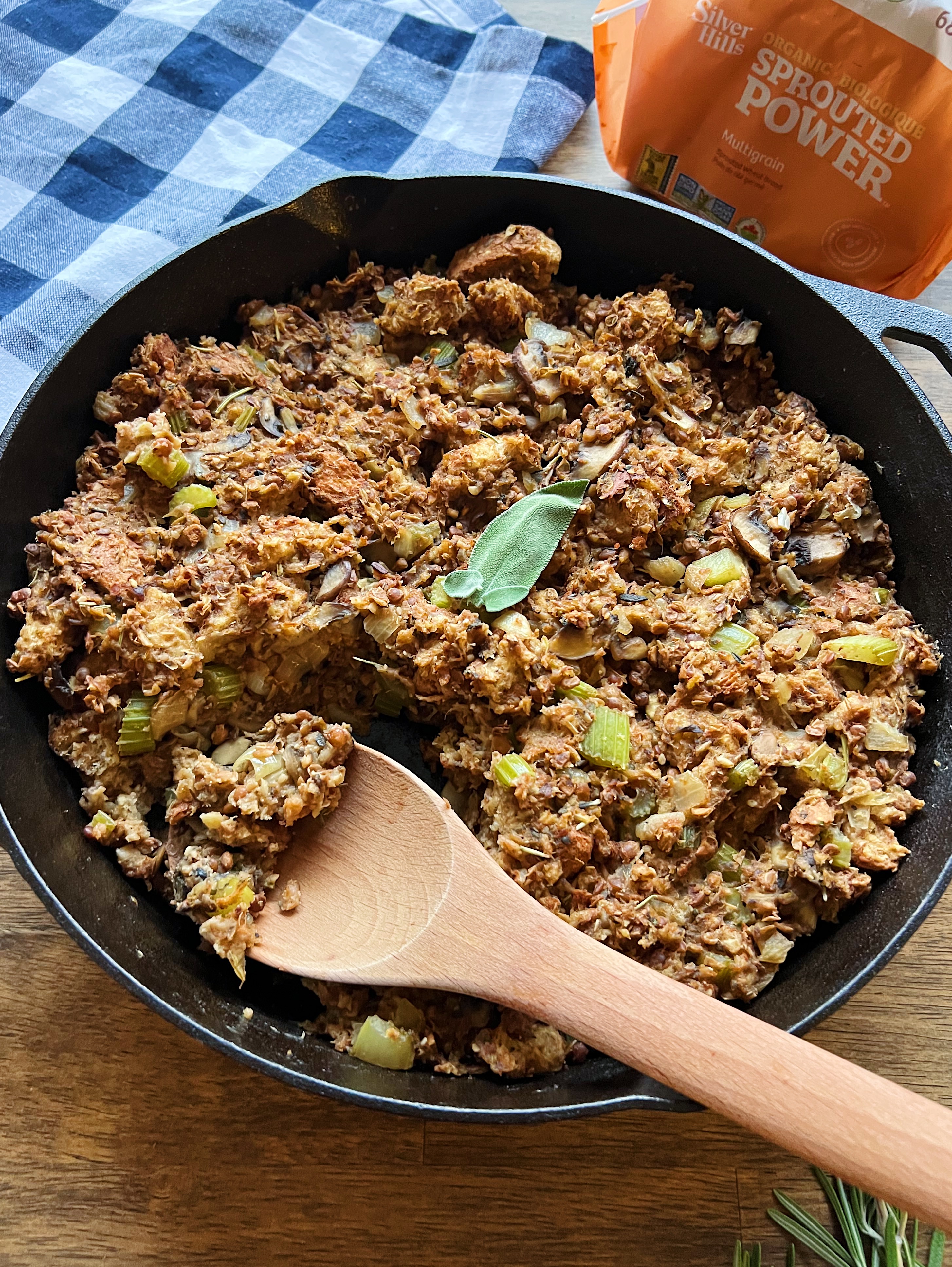 Vegan stuffing in a pan with a wooden spoon. 