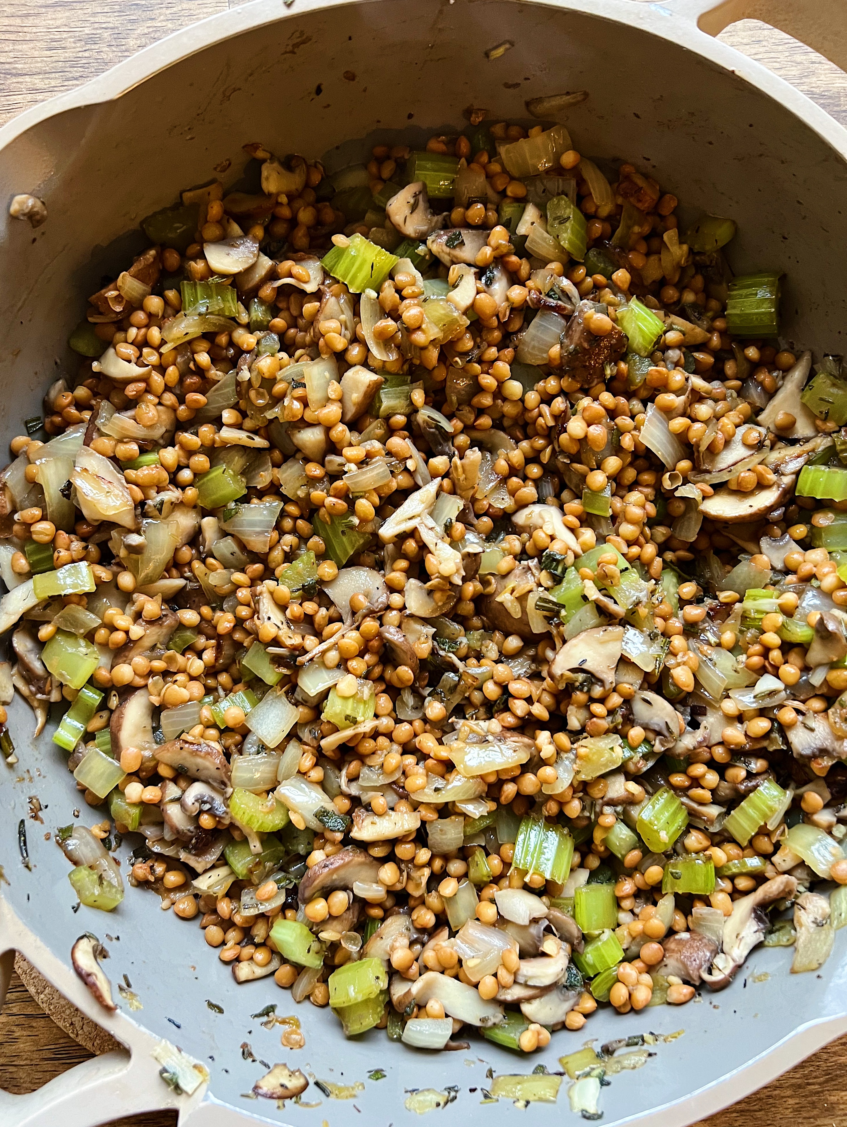 Lentils, mushrooms and celery in a pan. 