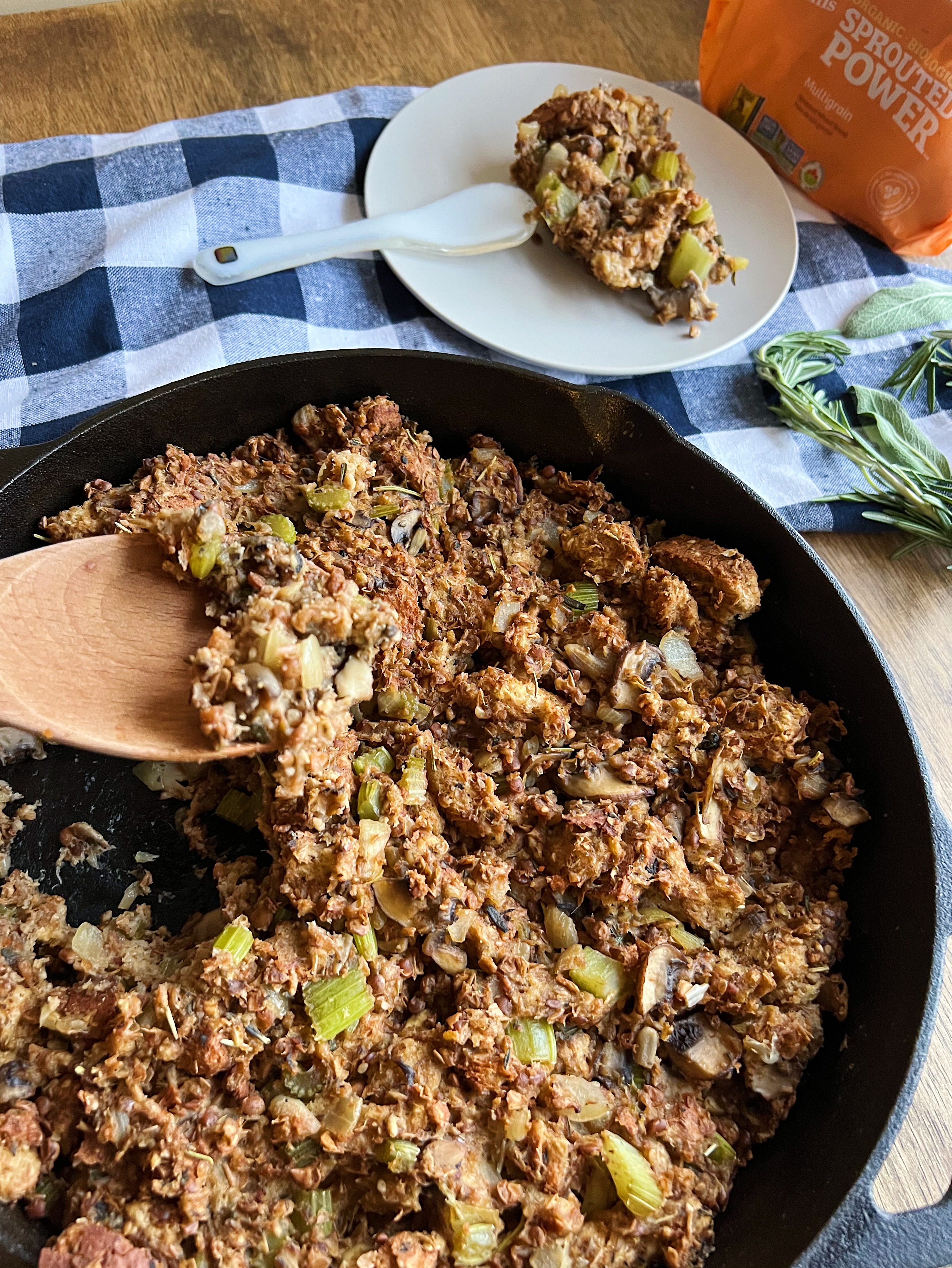 Vegan stuffing in a cast iron pan and a plate of it off to the side. 