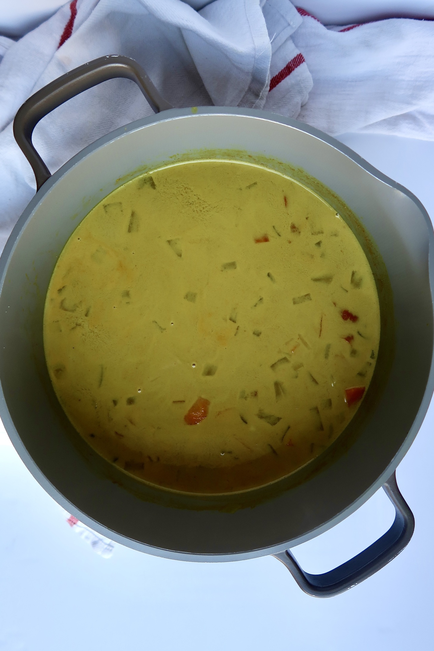 Large pot with a creamy, unblended soup inside.