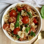 Bowl with pasta, cherry tomatoes, basil, lentils.
