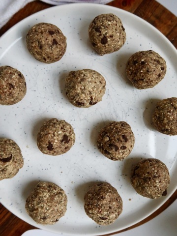 Overhead shot of cookie dough energy balls on a plate.