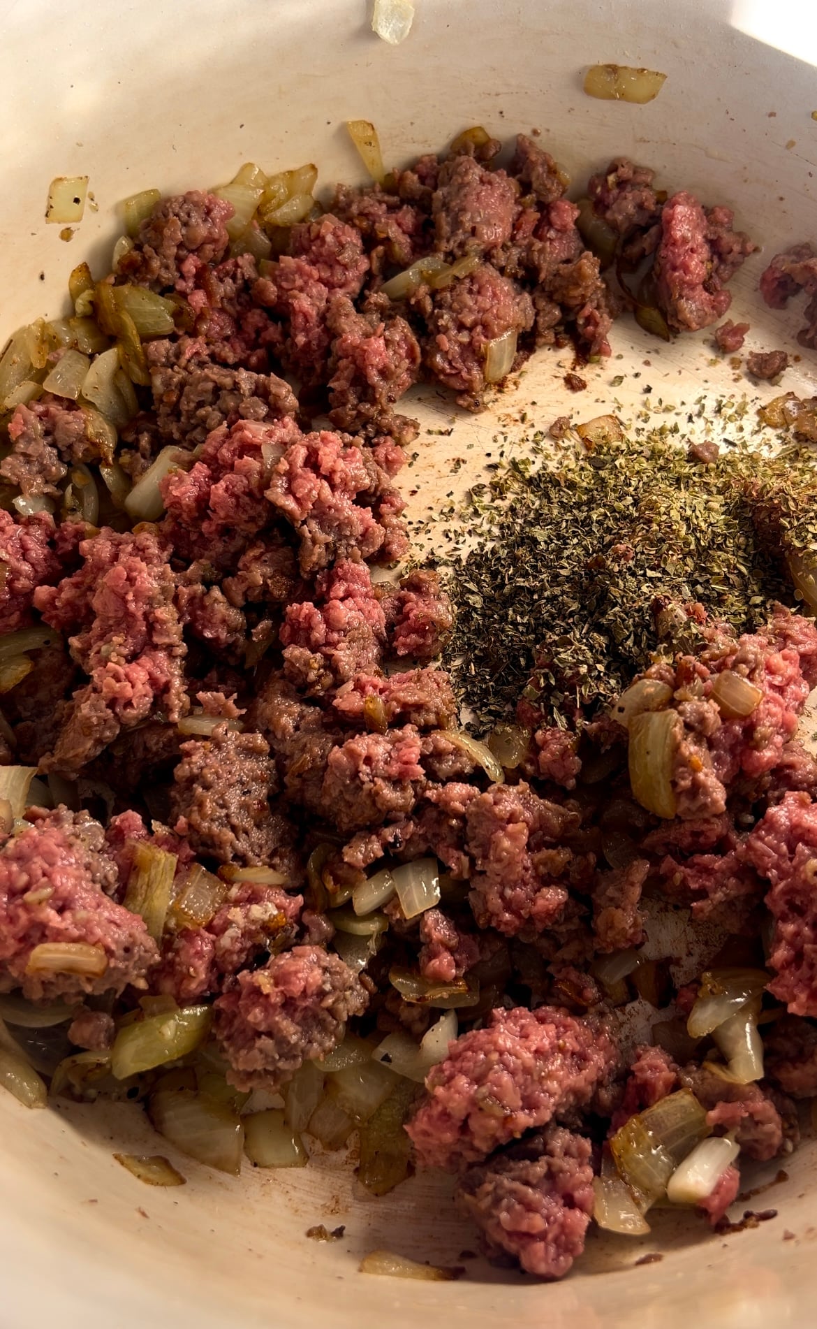 Vegan beef alternative being sauteed in a large pot with onion and lots of spices.