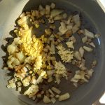 Pan with diced onion, garlic and ginger with spices.