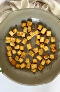 Teriyaki tofu cooking in a pan.
