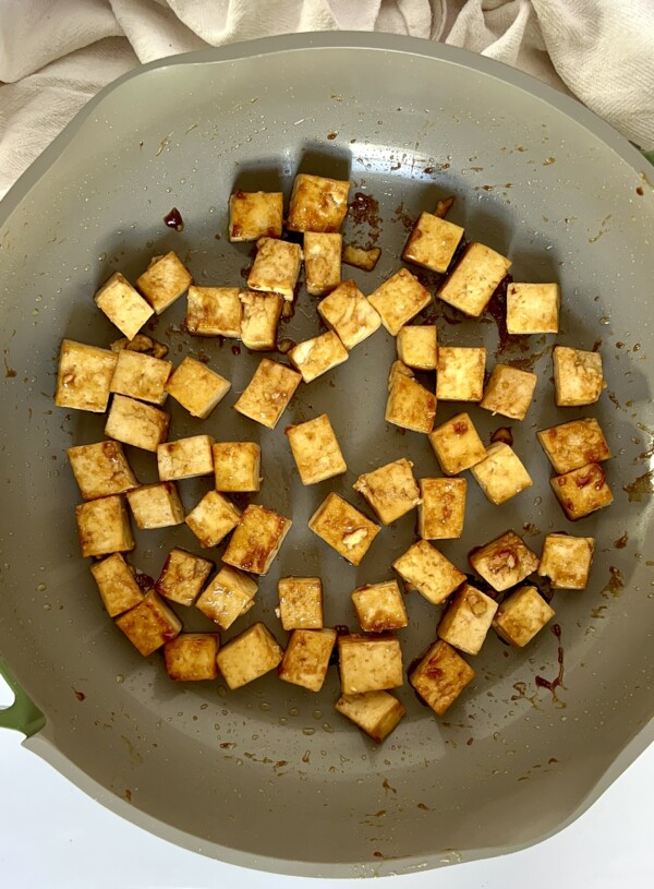 Teriyaki tofu cooking in a pan.