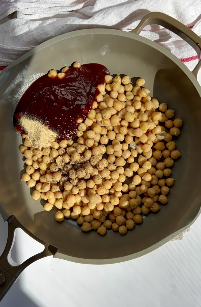 Pan with chickpeas in it as well as BBQ sauce and garlic powder