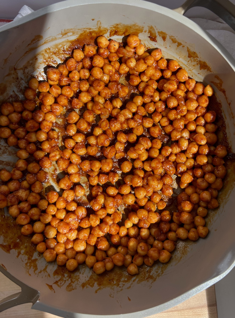 Pan with chickpeas covered in BBQ sauce.