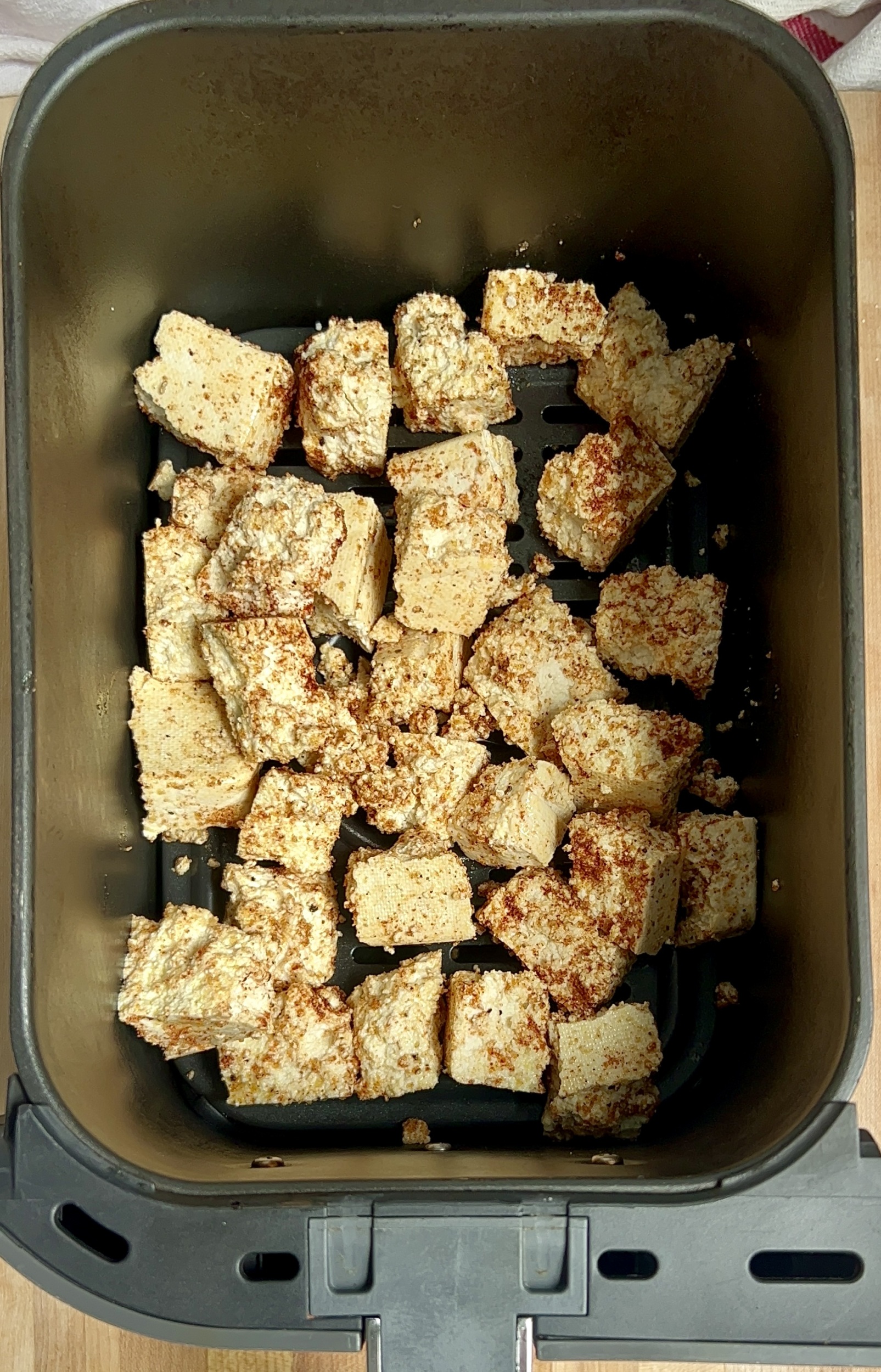 Cubed tofu in an air fryer basket