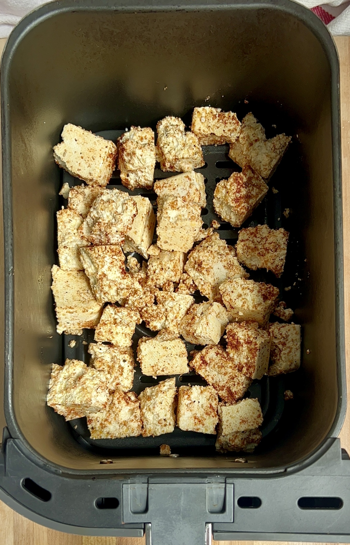 Cubed tofu in an air fryer basket