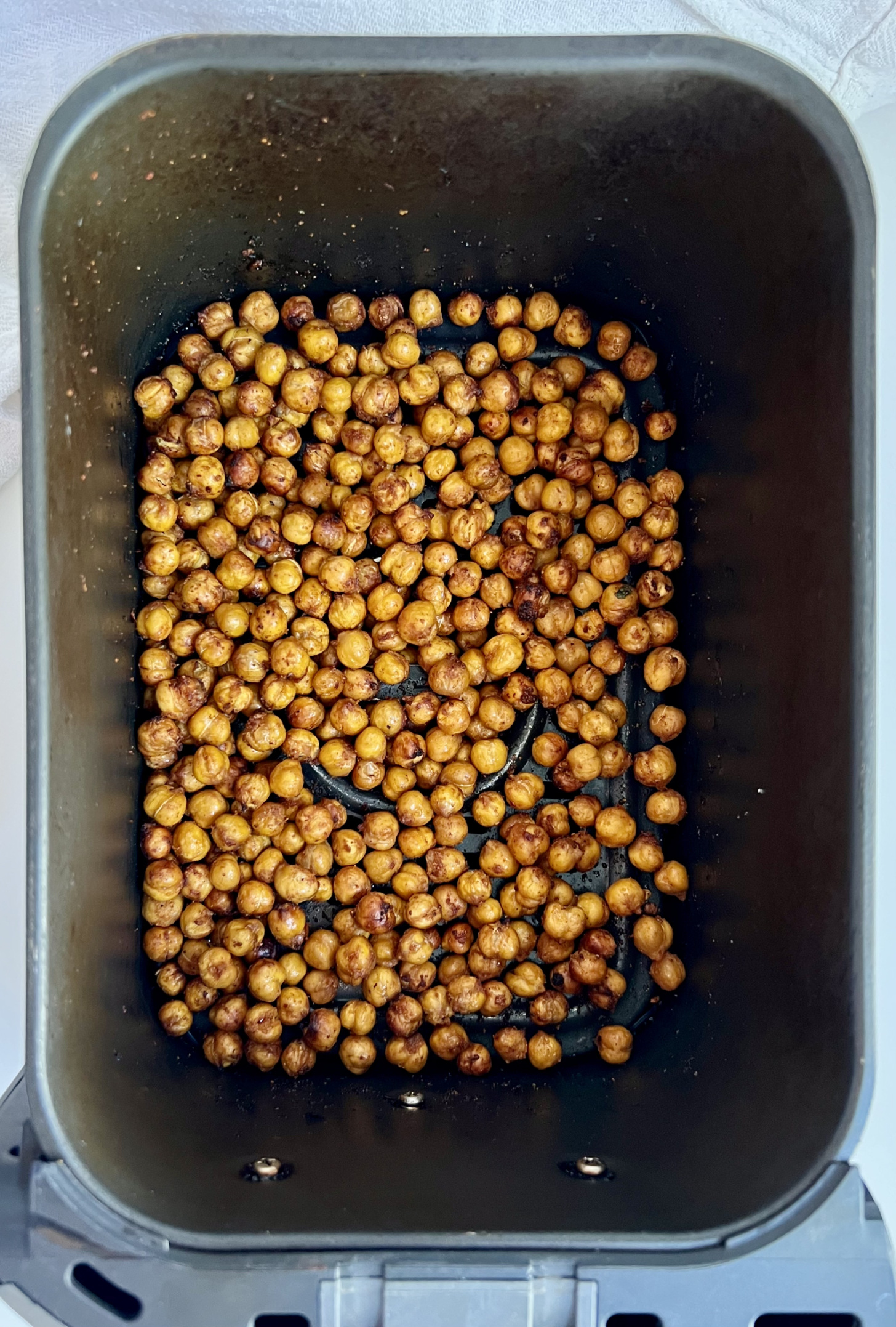 Air fryer with roasted chickpeas inside