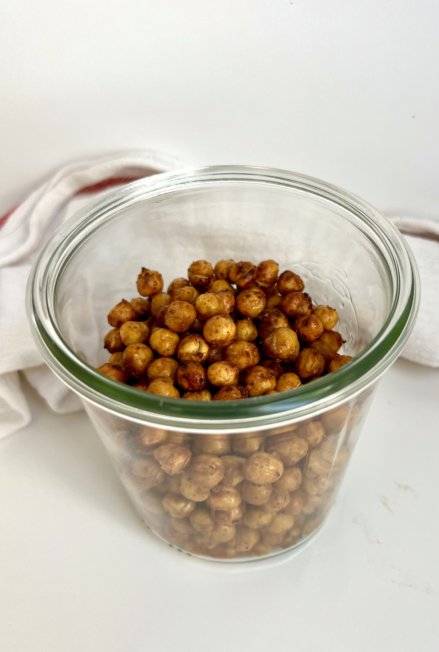 Jar on a white background with roasted chickpeas inside