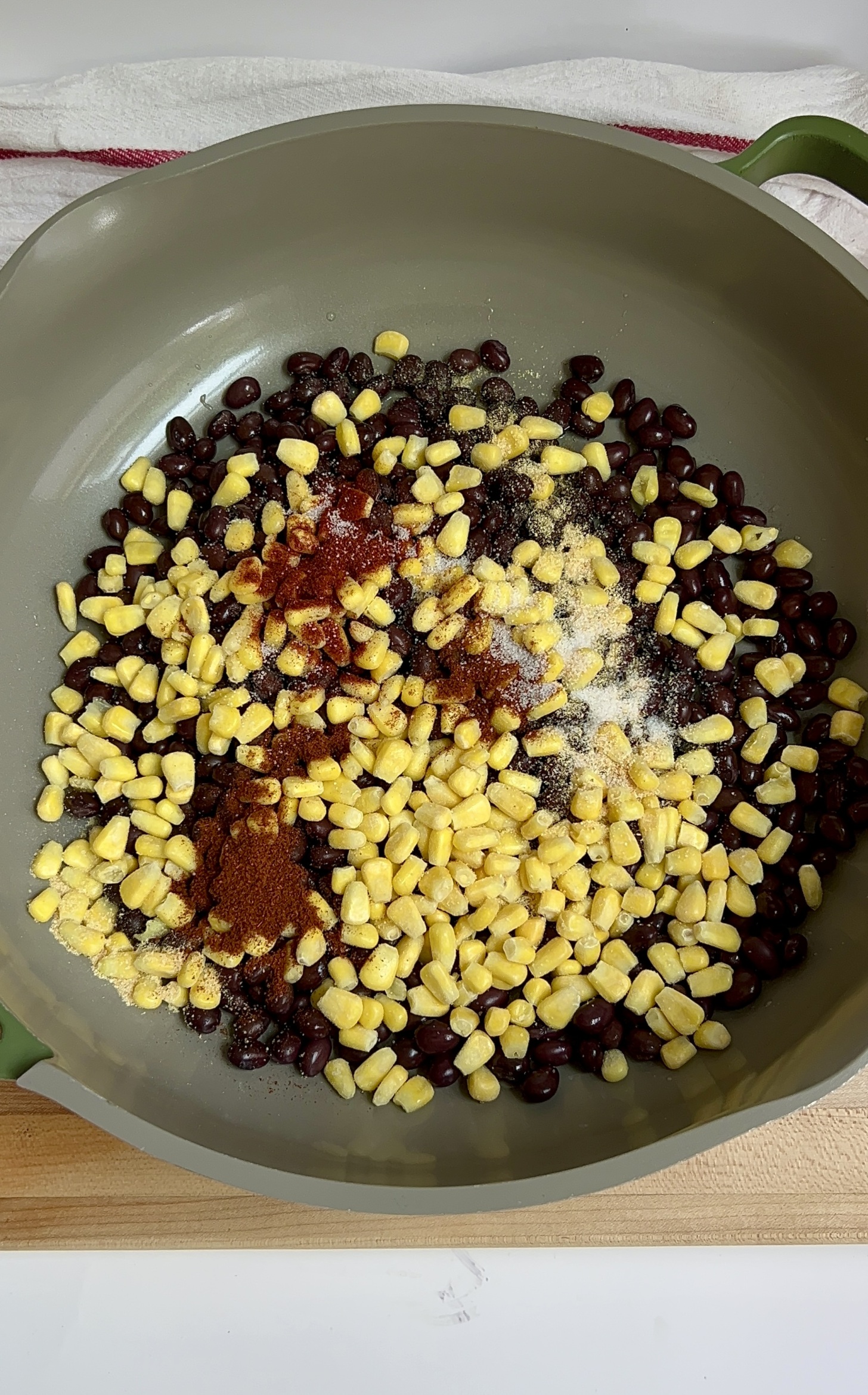 Pan with black beans, corn and spices on top.