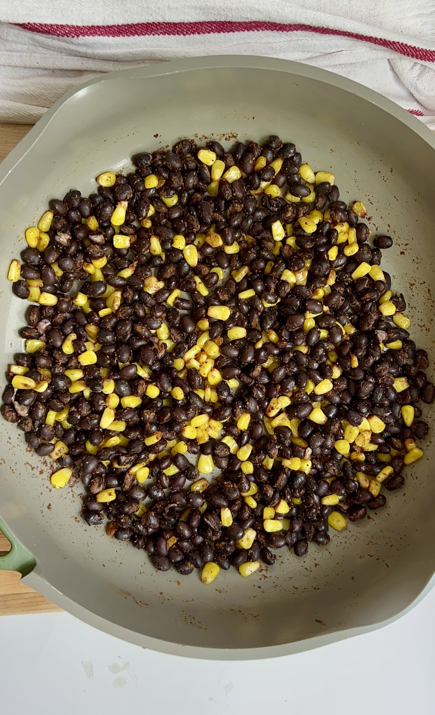 Pan with cooked black beans and corn.