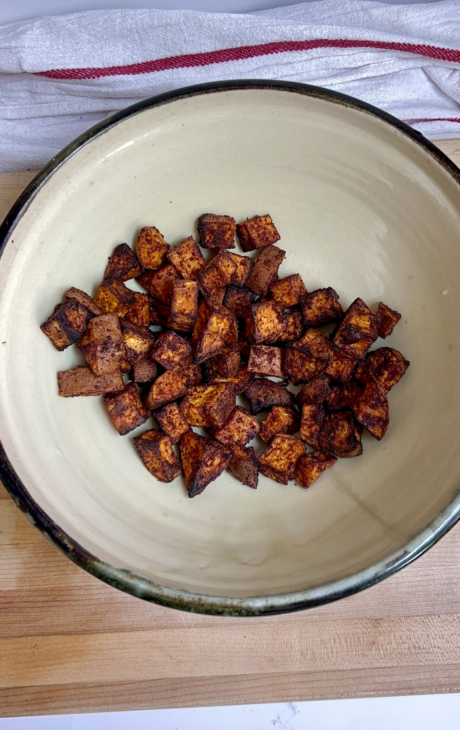Bowl with roasted sweet potatoes inside.