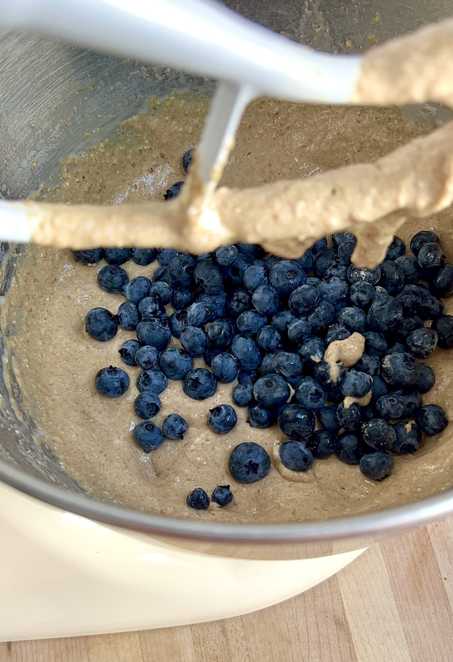 Mixing bowl with batter and blueberries inside.