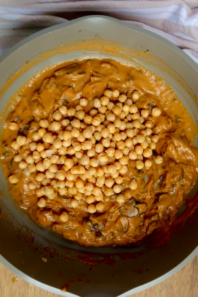 Pan with pumpkin sauce inside and chickpeas