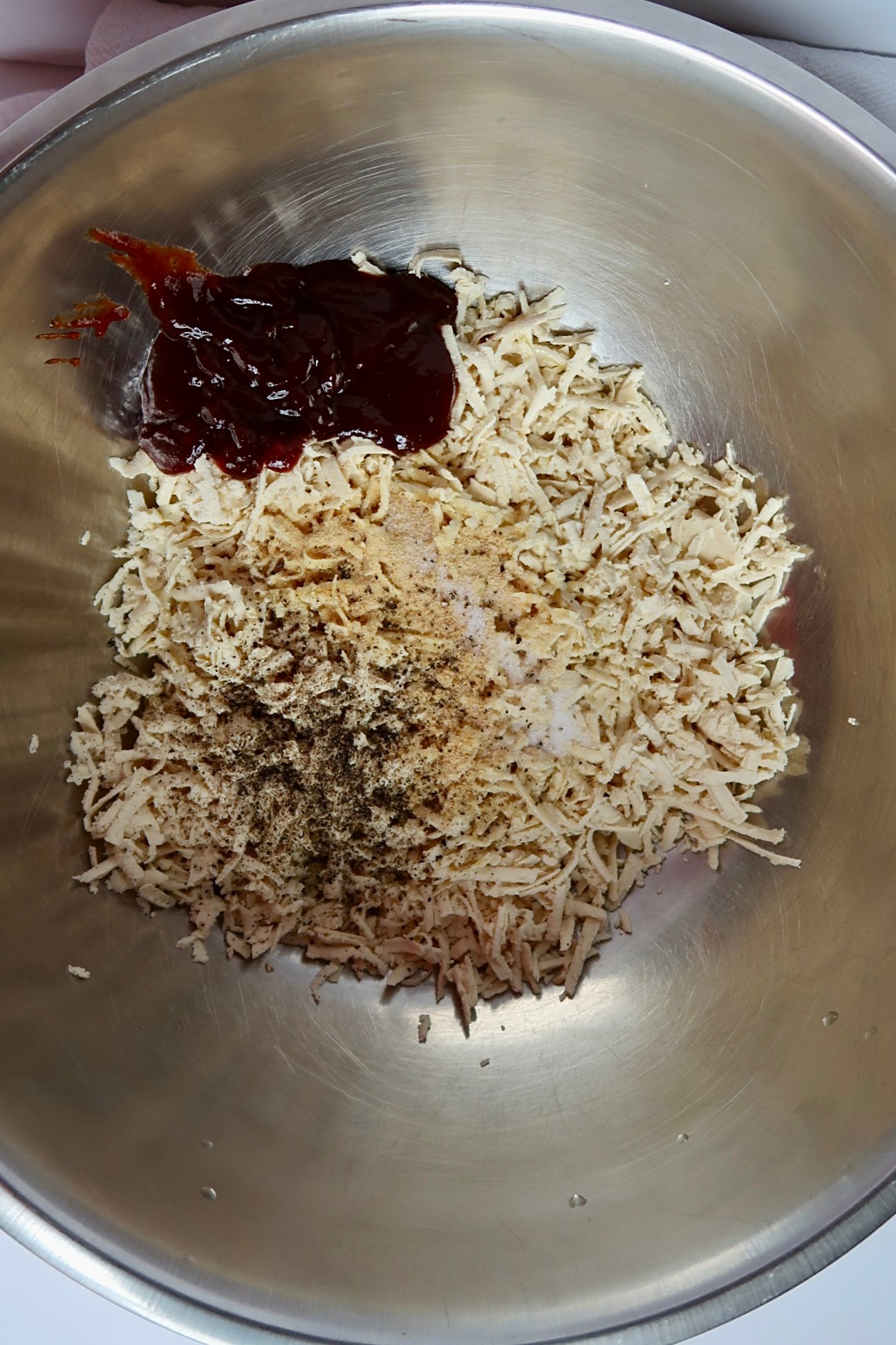 Shredded tofu in a bowl with barbecue sauce and spices