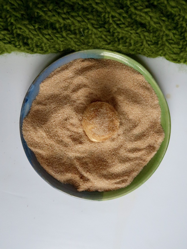 Rolled cookie dipped in cinnamon sugar mixture