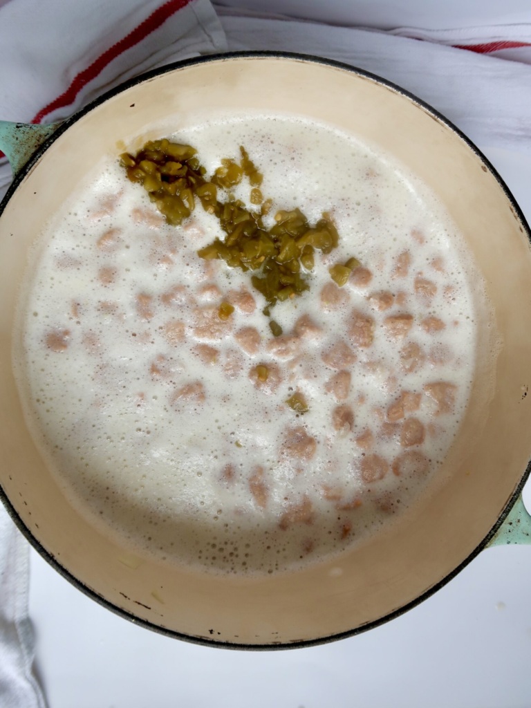 Large pot with soy curls and a creamy base with diced green chilis.