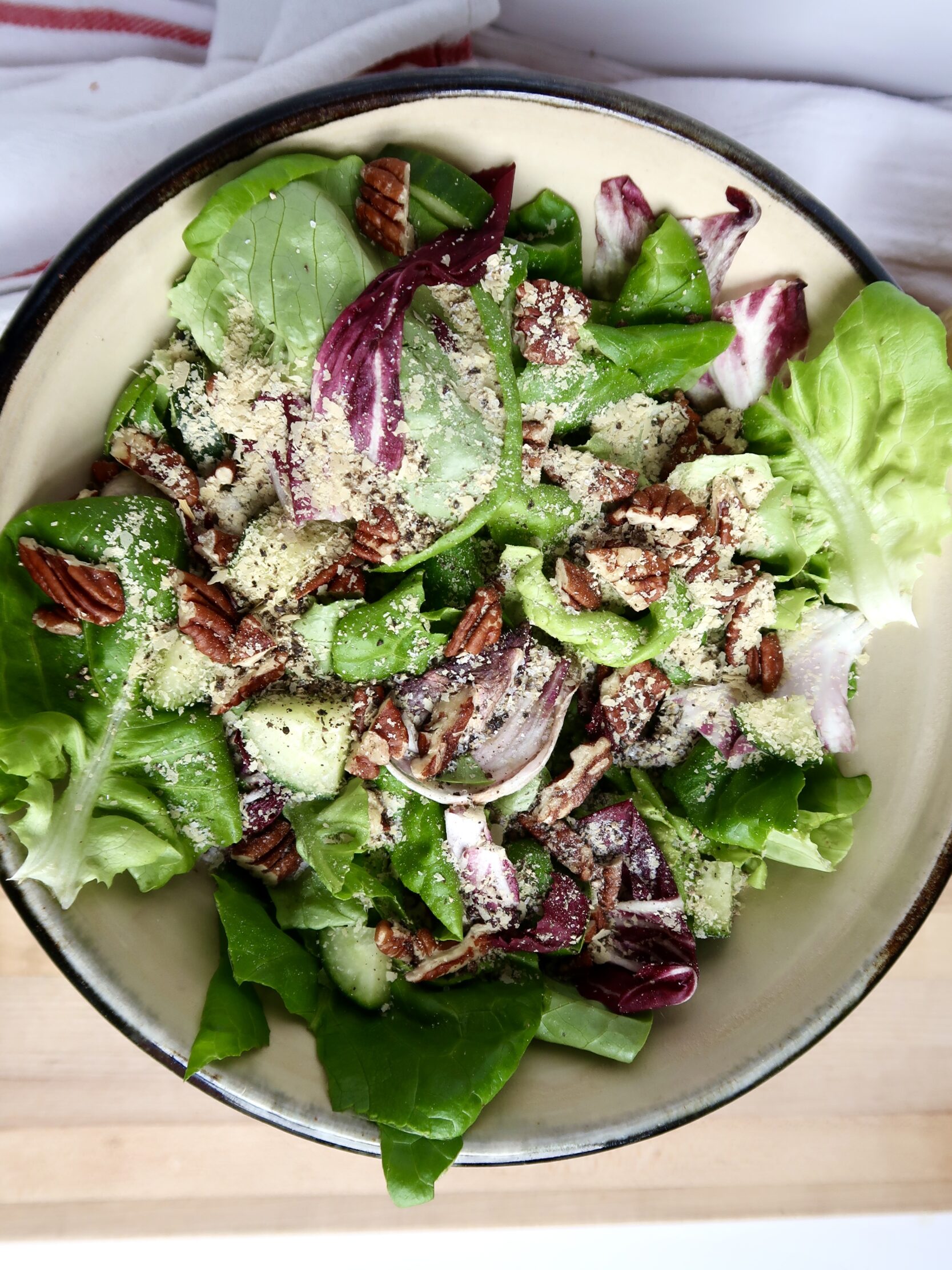 Bowl with greens and radicchio on top with nutritional yeast.