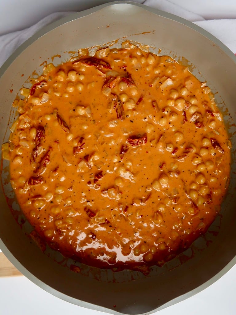 Pan with chickpeas and coconut milk mixed with tomato paste with sundried tomatoes in it.