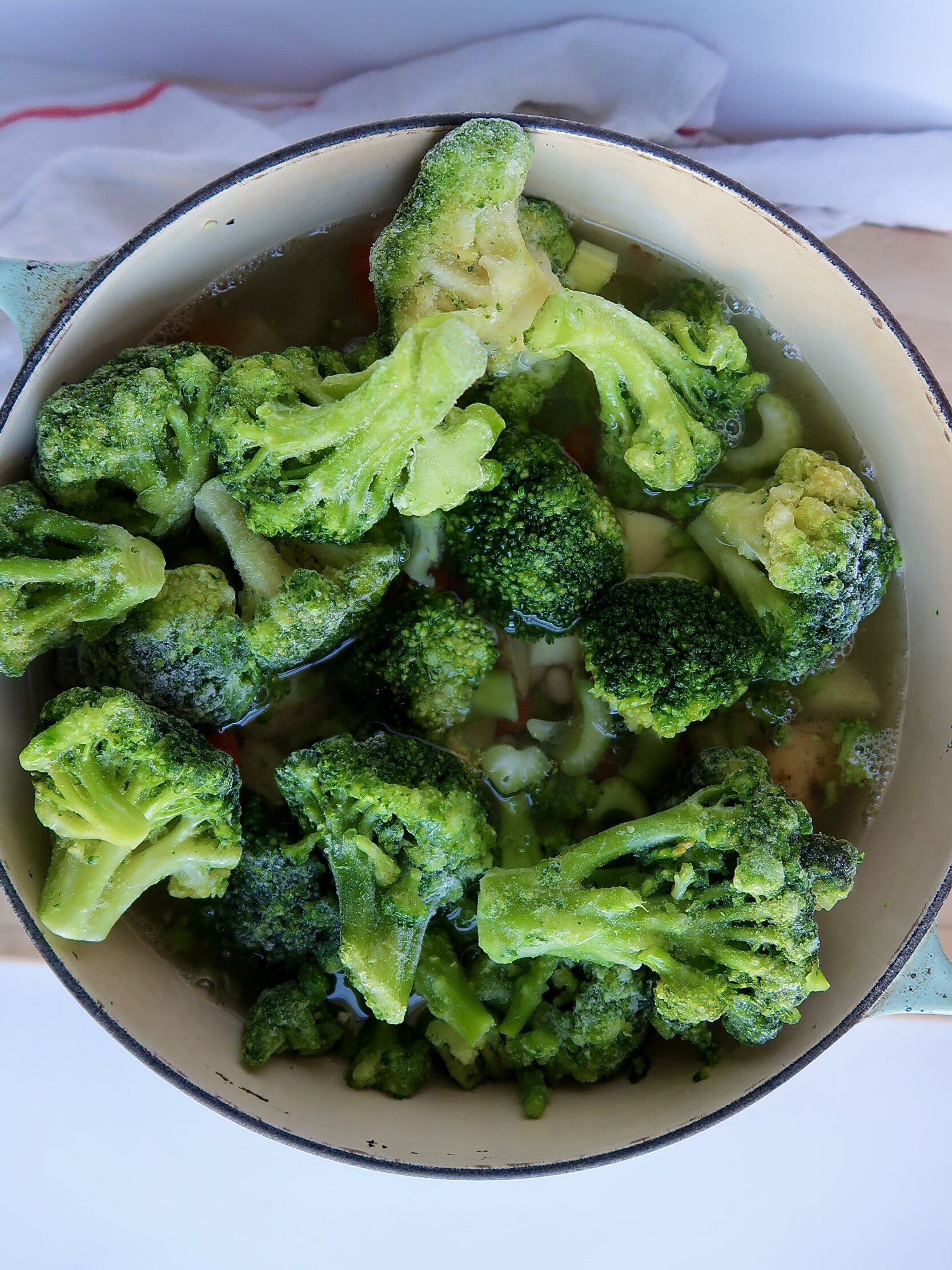 Large pot with broccoli, chopped potatoes and carrots in it.