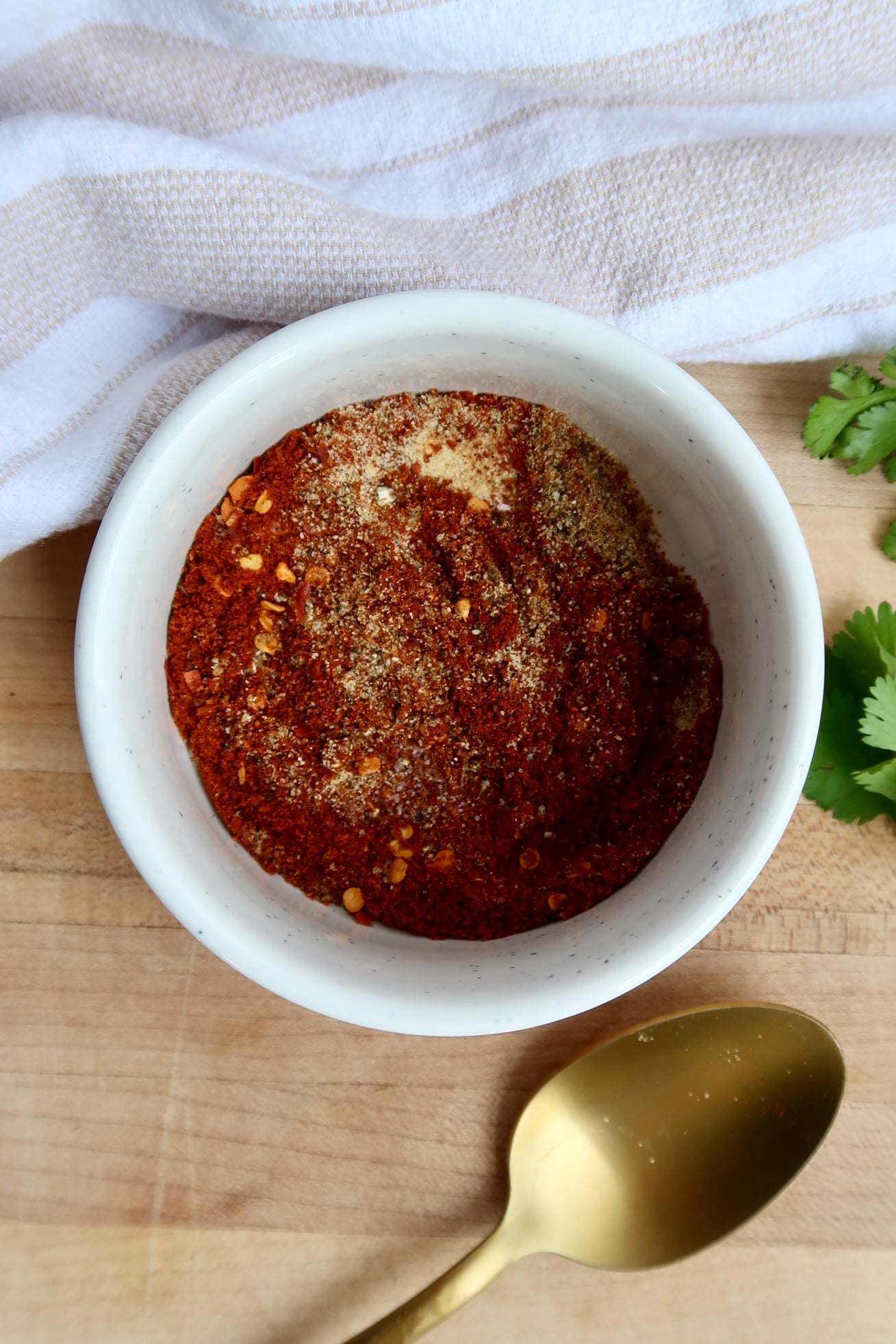 Small white ramekin with mixed spices in it.