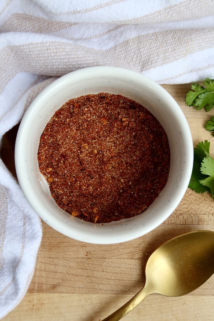 White ramekin with chili spices in it.