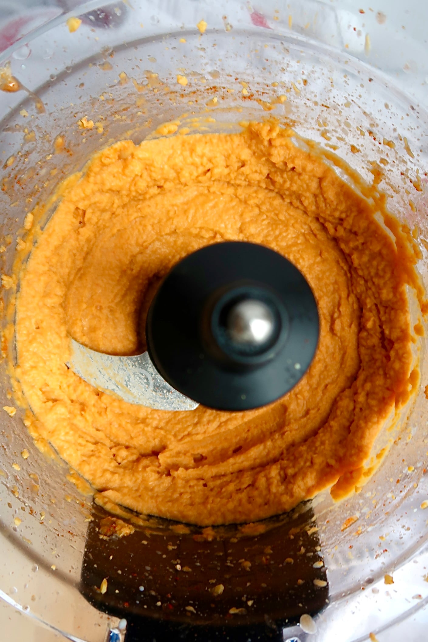 Blended chickpea buffalo dip in a food processor.