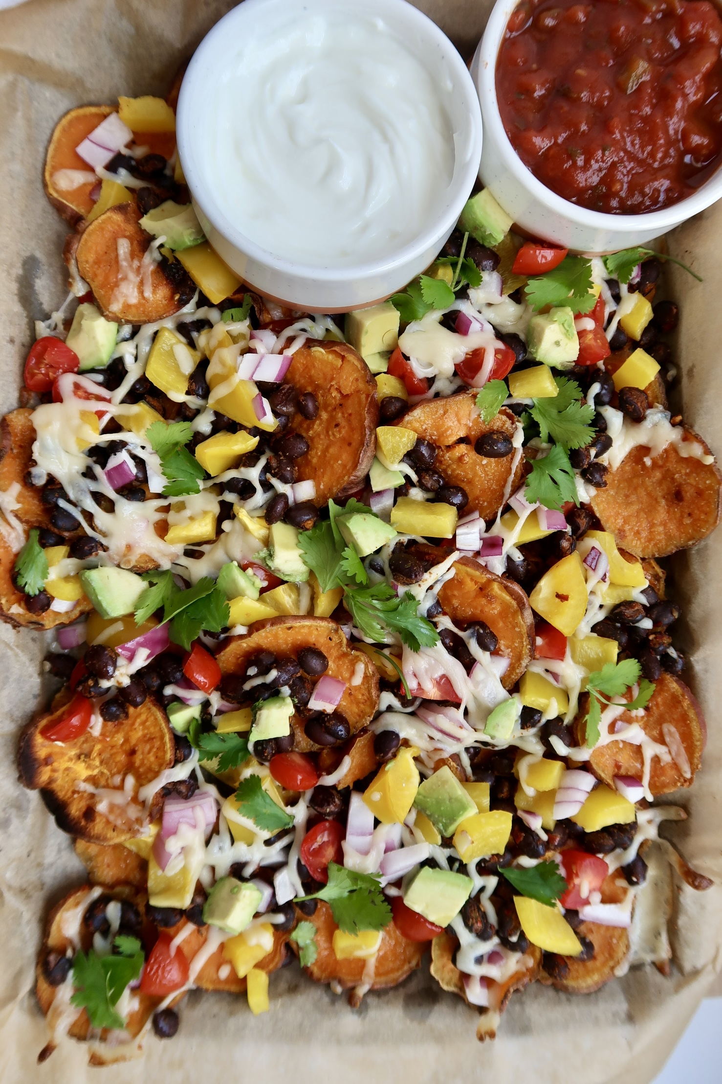 Sweet potato nachos with salsa and sour cream on the side.