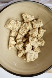 Tofu in a bowl with seasoning on it.