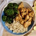 Tofu with lemon pepper seasoning in a bowl with brown rice and broccoli to the side.