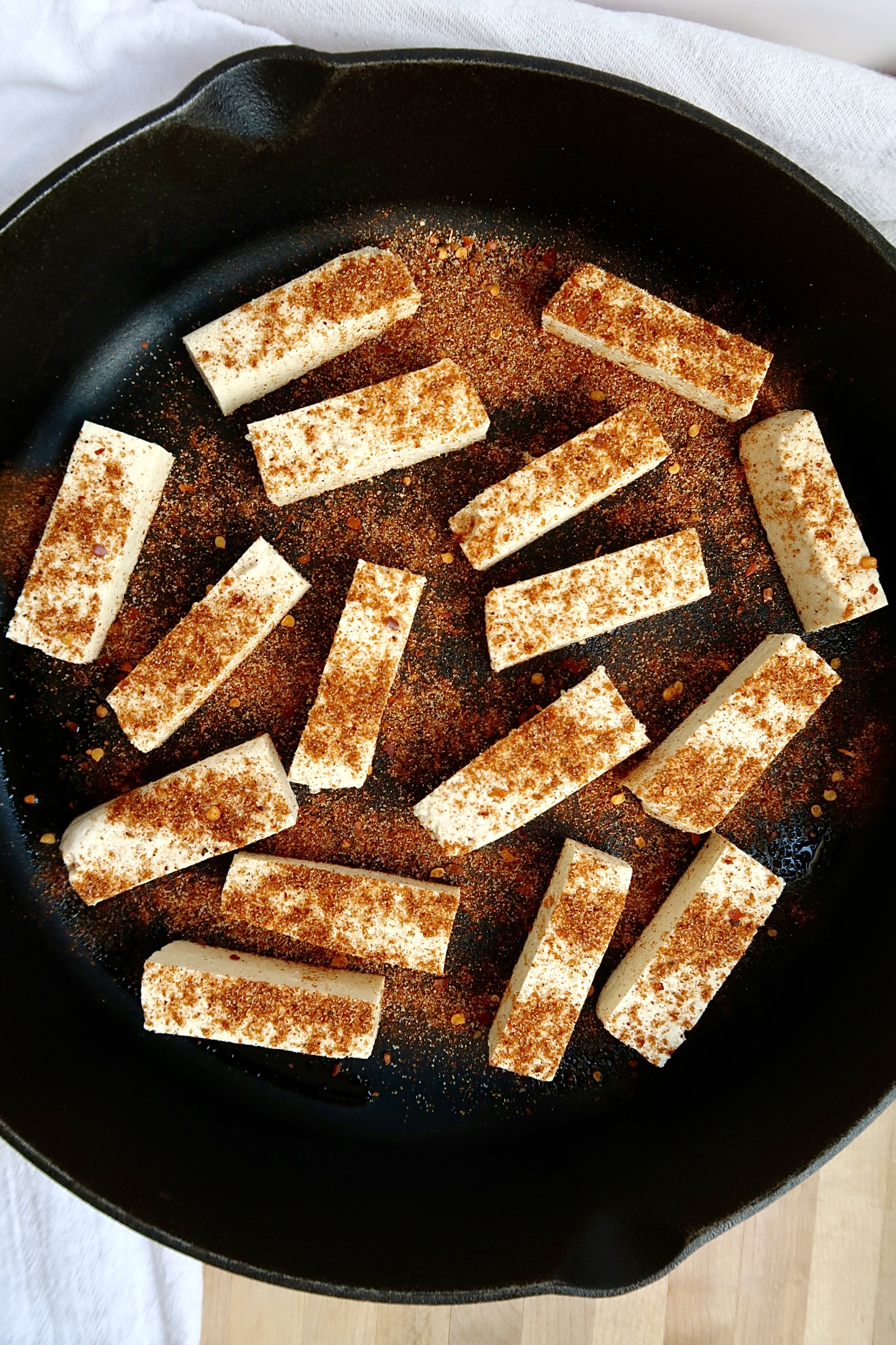 Pan with strips of tofu and seasoning.