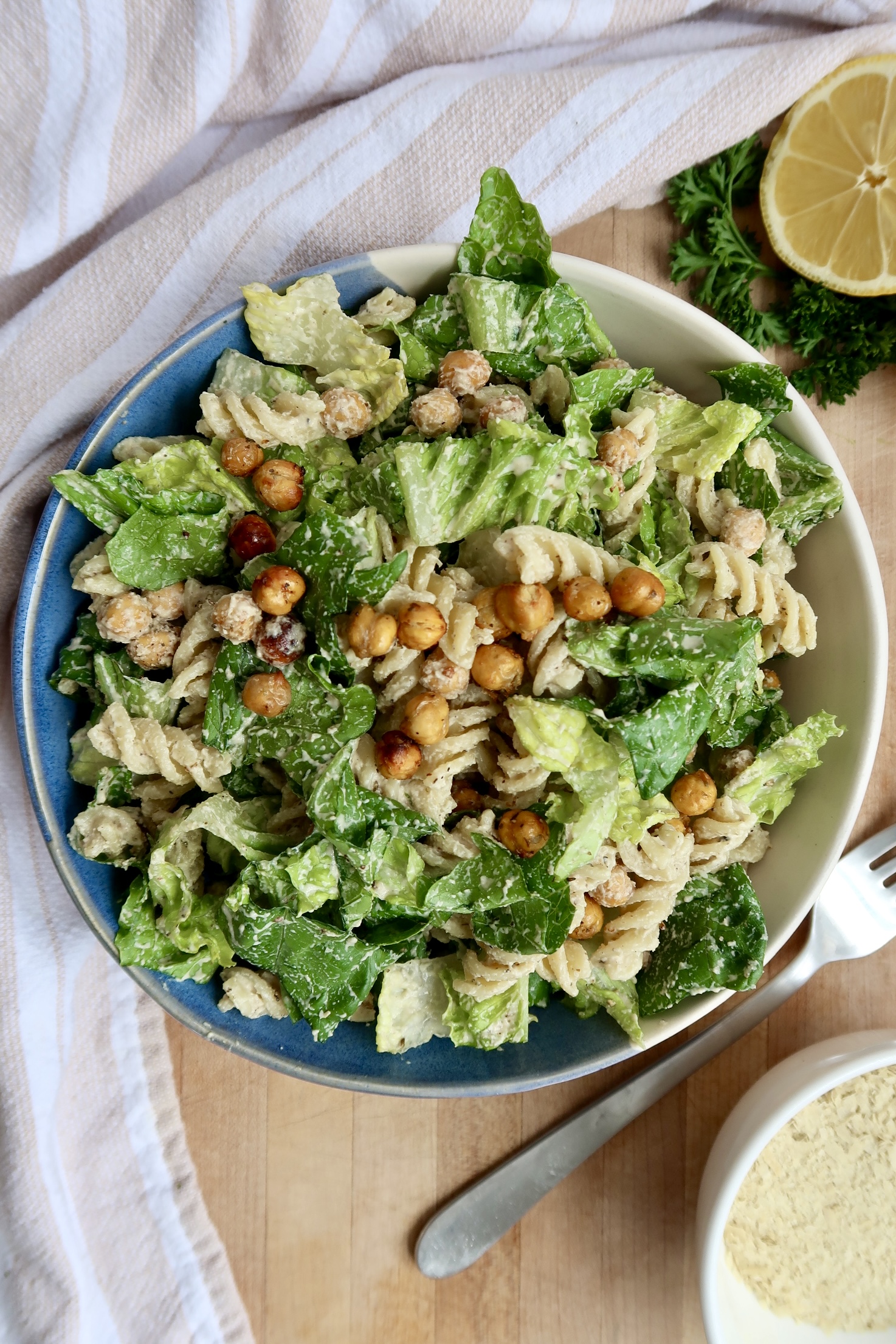 Bowl with romaine lettuce, pasta, crispy chickpeas.