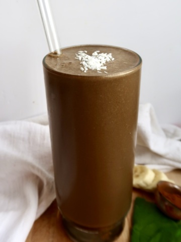 Banana Chocolate Smoothie in a glass with a straw.
