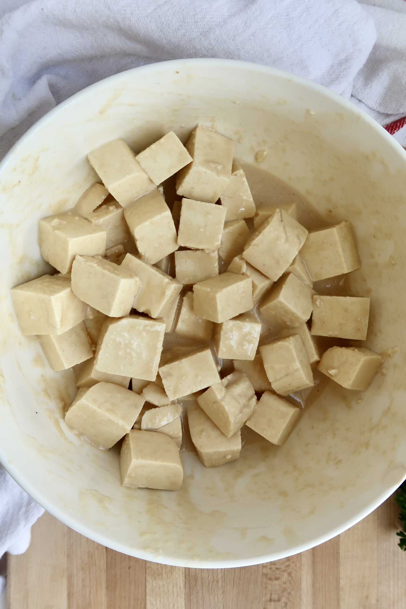 Bowl of cubed tofu with batter on it.
