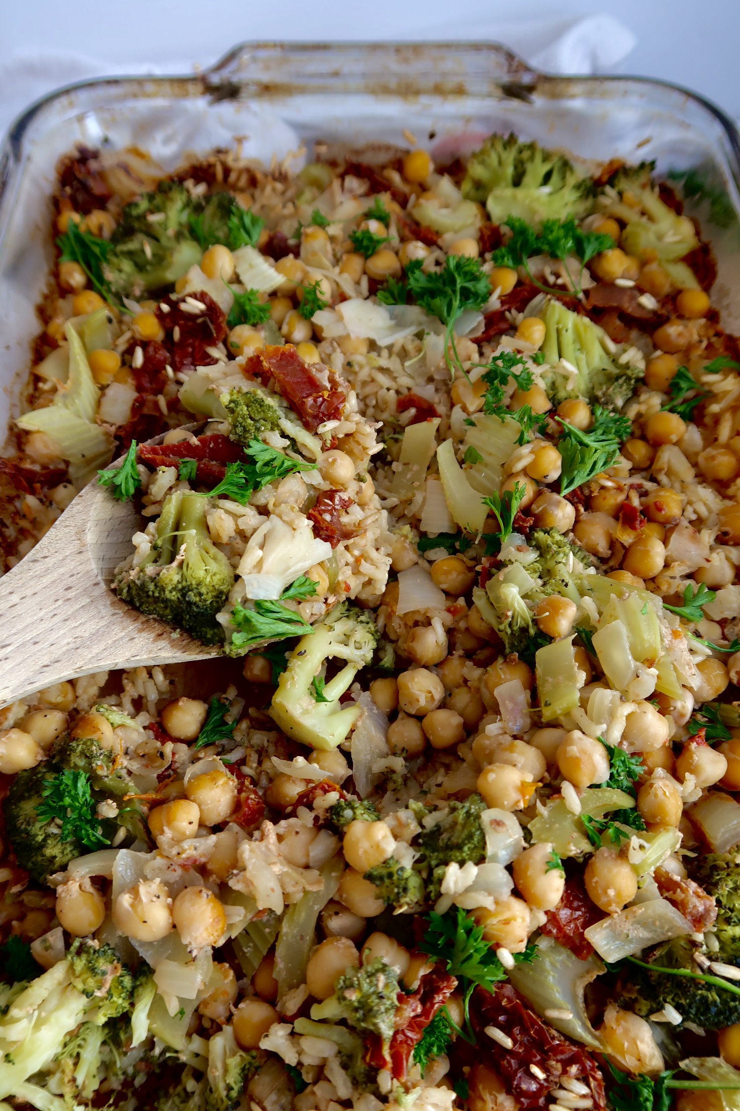 Chickpea casserole with a spoon scooping some.